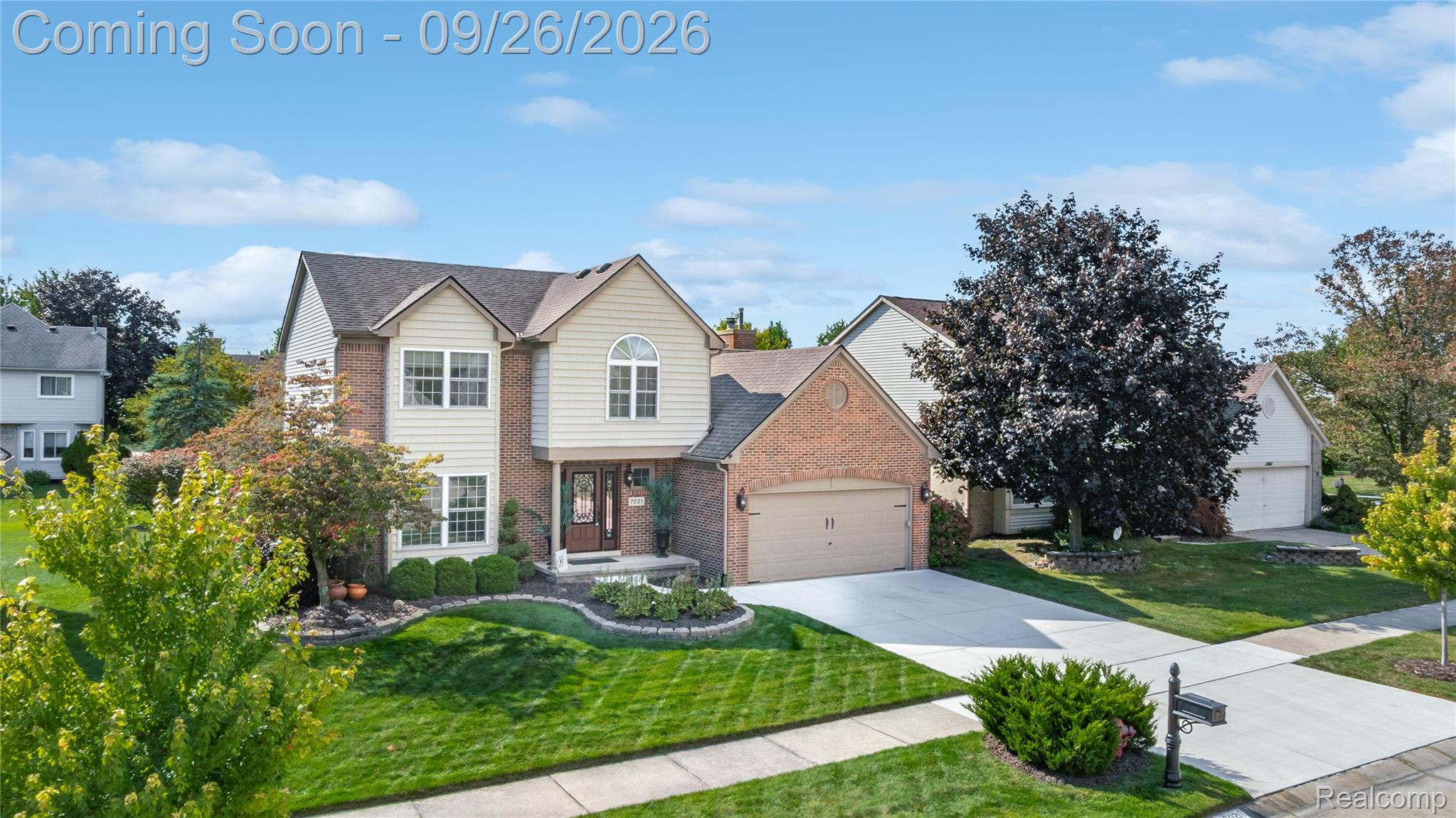 7021 Fox Path Canton, MI 48187 - Photo 52 of 59 Brick and siding exterior featuring a prominent arched window and a two-car attached garage