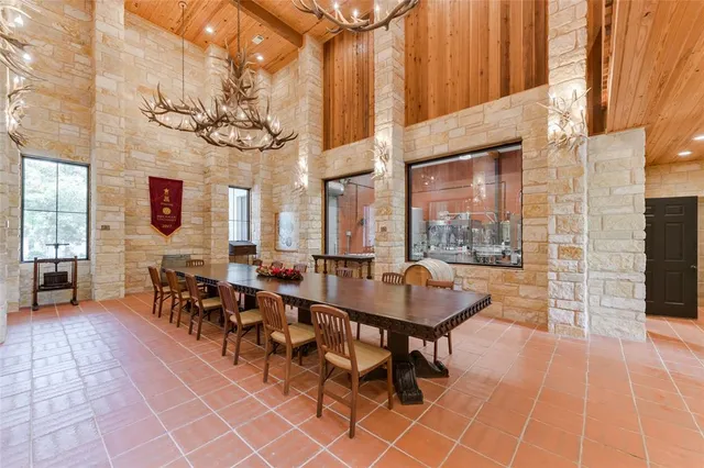 a outdoor space with lots of tables a chandelier and couch