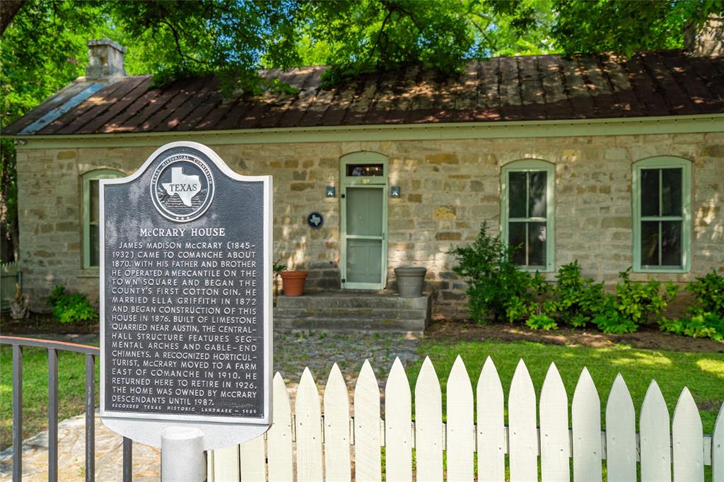 802 South Austin Street Comanche, TX 76442 - Photo 2 of 20 a view of brick house with a wooden fence