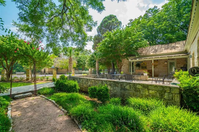 a view of a house with a yard and sitting area