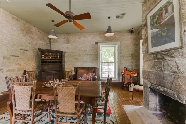 a living room with furniture a fireplace and a chandelier