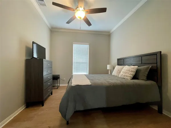 a bedroom with a bed and a chandelier