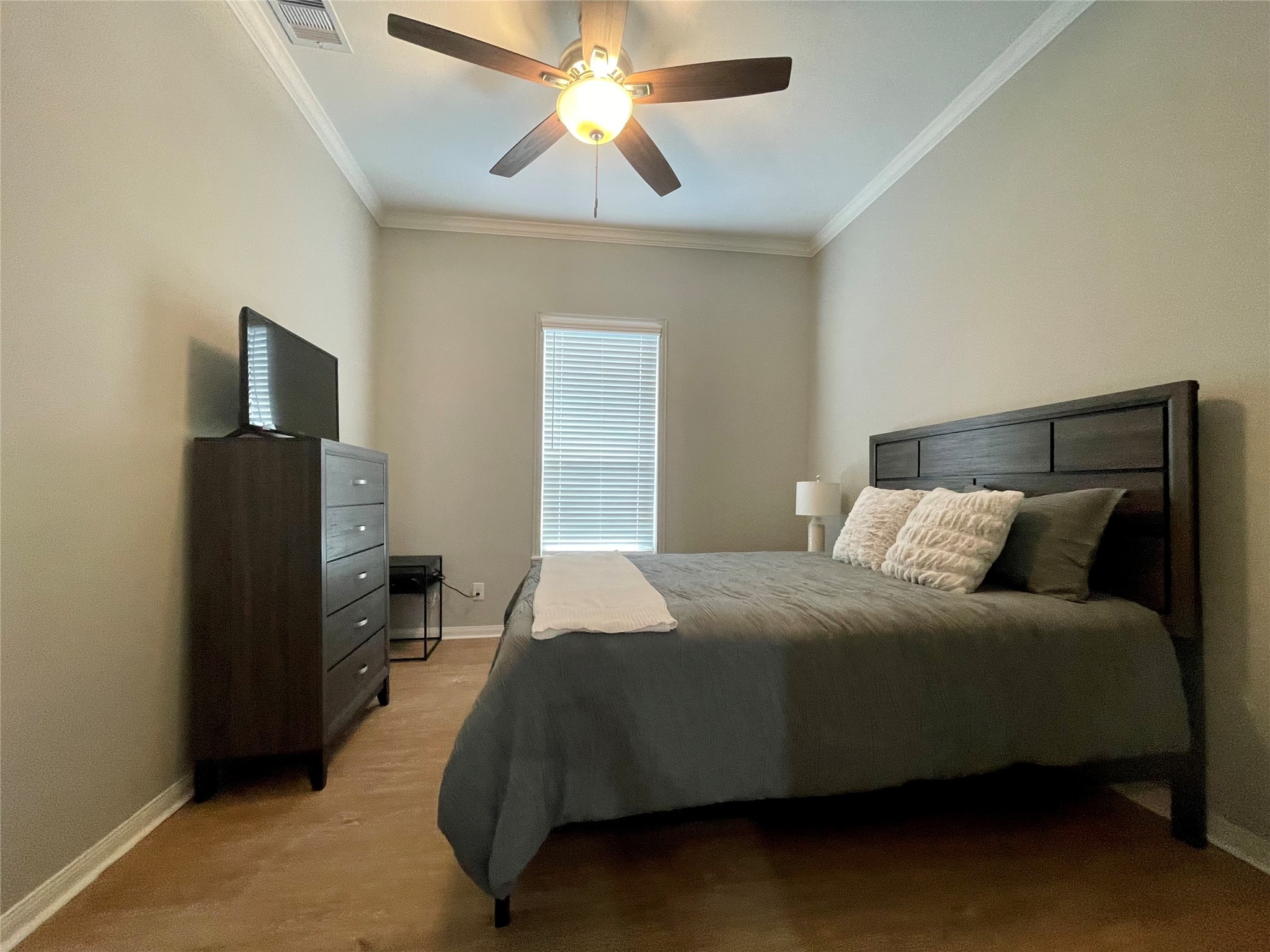 1714 Mary Street, Unit A Houston, TX 77026 - Photo 11 of 19 a bedroom with a bed and a chandelier