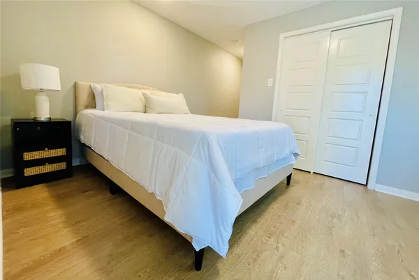a bed room with a bed and a night stand