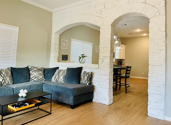 a living room with furniture and a chandelier