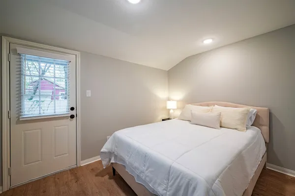 a bedroom with a bed and a window