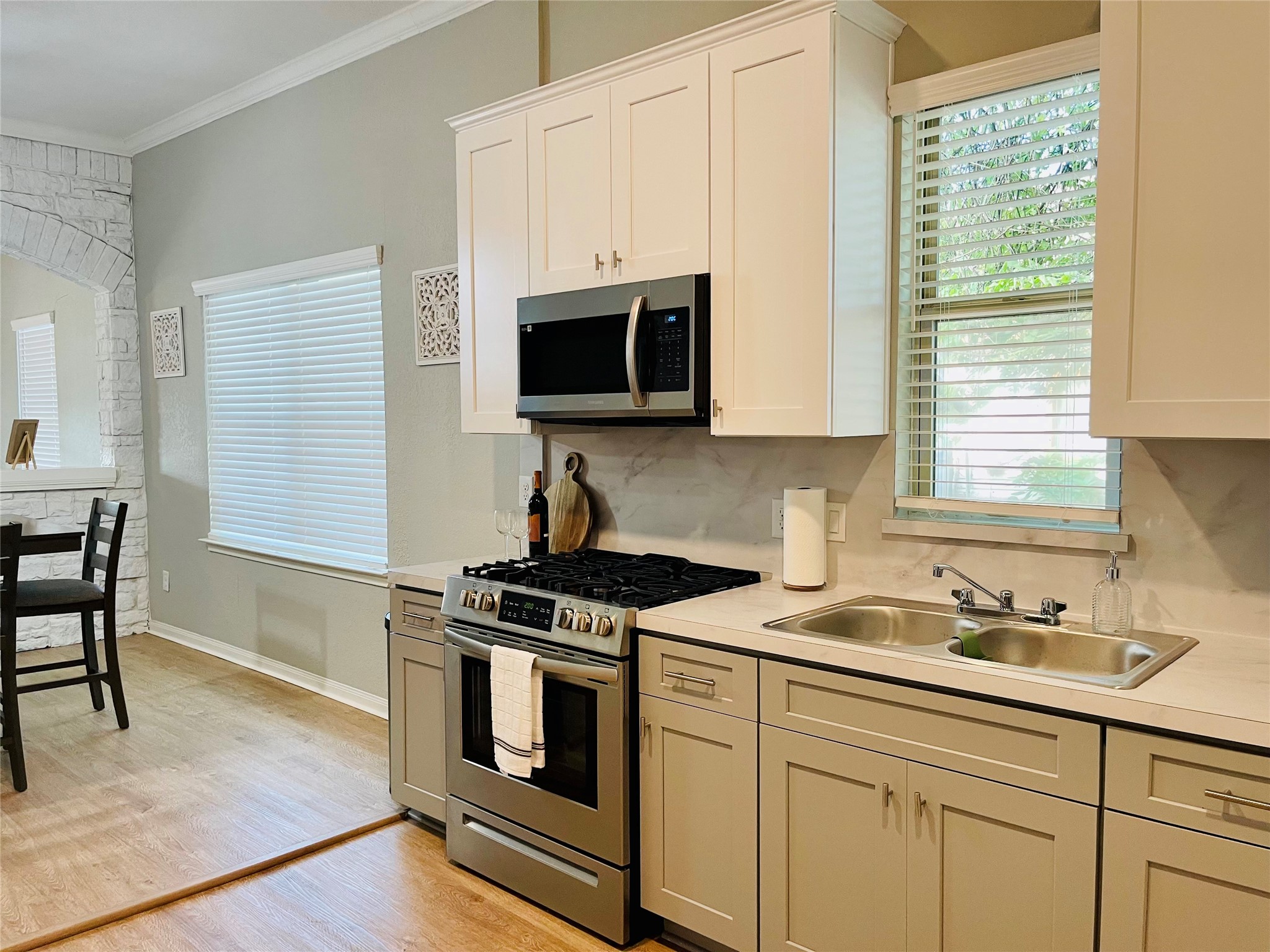 1714 Mary Street, Unit A Houston, TX 77026 - Photo 7 of 19 a kitchen with stainless steel appliances white cabinets and a stove top oven