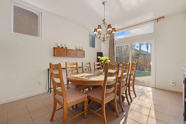 a view of a dining room with furniture and chandelier