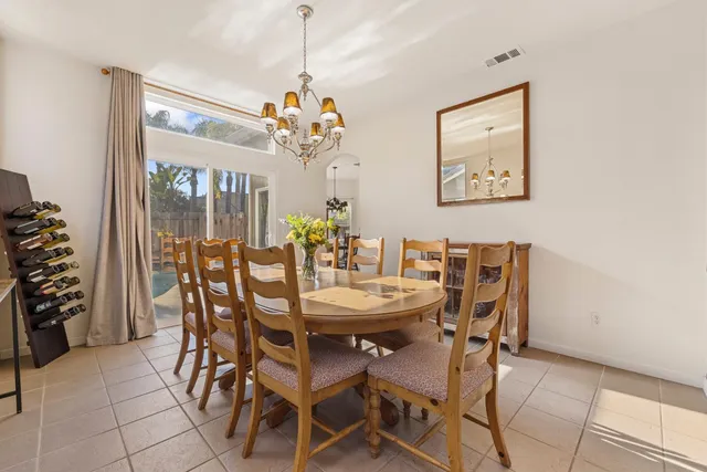 a kitchen with cabinets and chairs