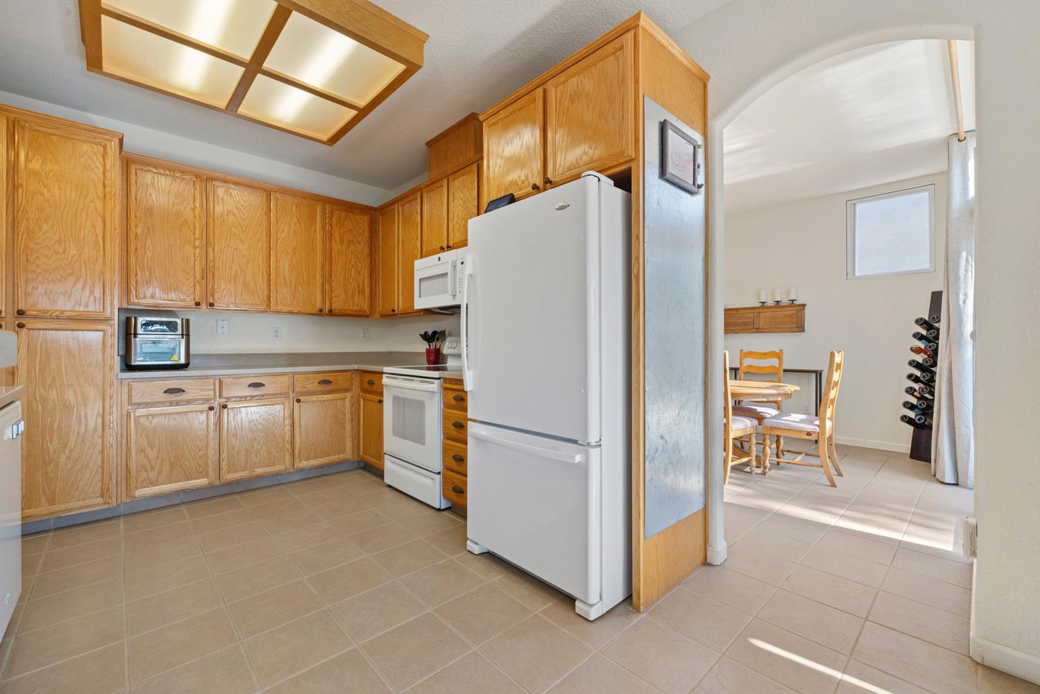2730 Explorer Way Turlock, CA 95382 - Photo 14 of 64 a white refrigerator freezer sitting inside of a kitchen