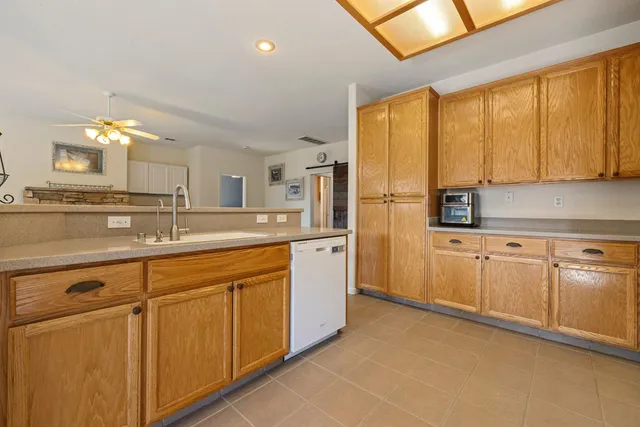 a kitchen with cabinets and chairs
