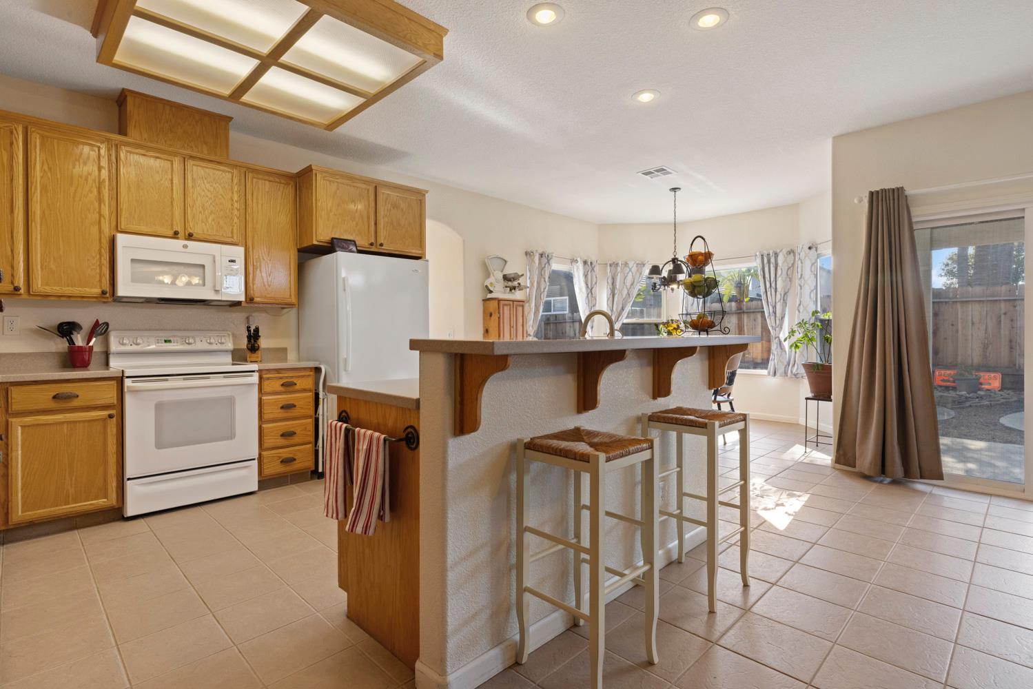 2730 Explorer Way Turlock, CA 95382 - Photo 18 of 64 a kitchen with cabinets and chairs