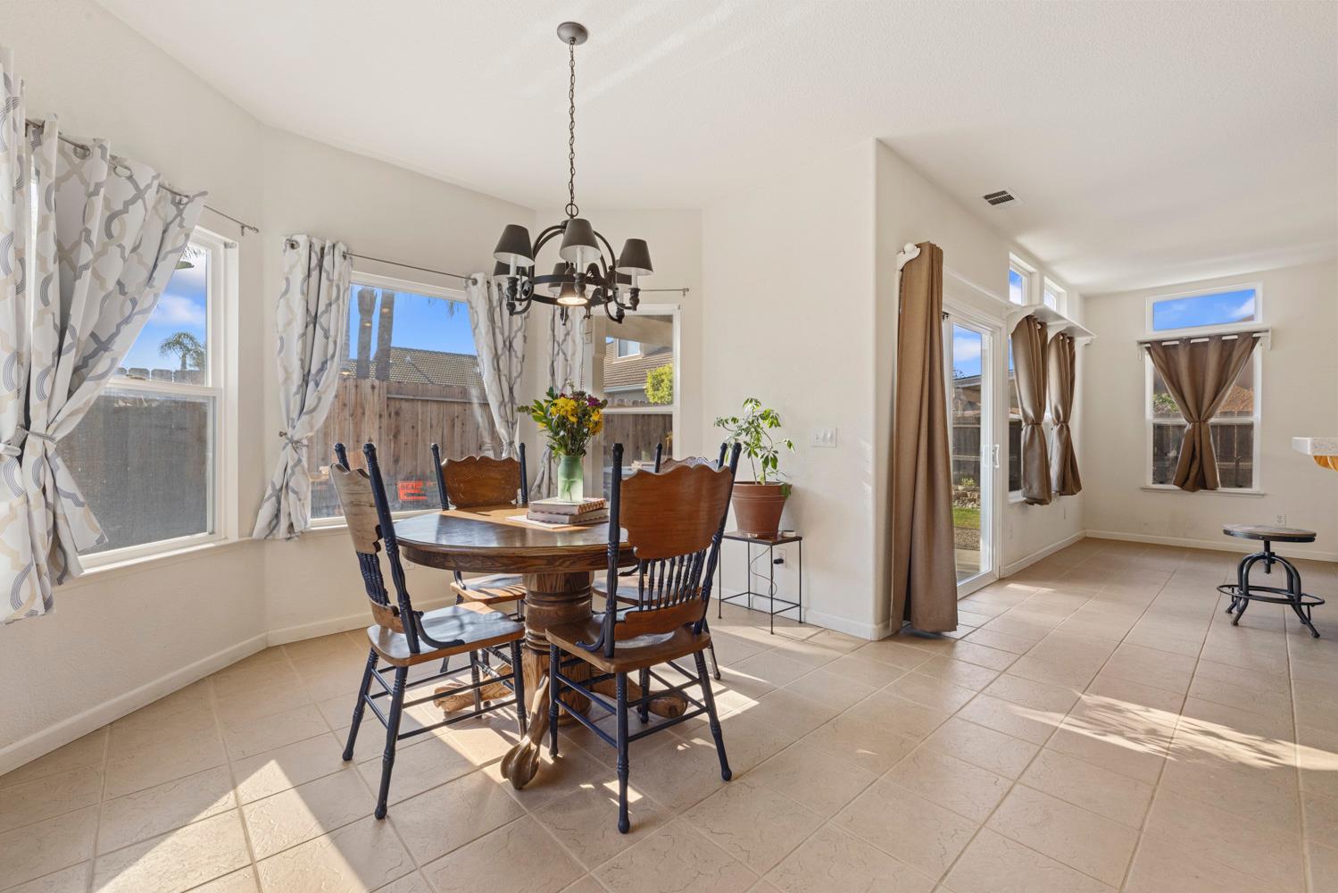 2730 Explorer Way Turlock, CA 95382 - Photo 21 of 64 a view of a dining room with furniture and chandelier