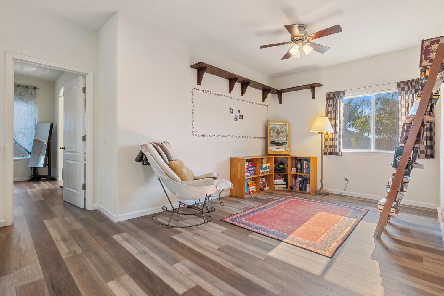 2730 Explorer Way Turlock, CA 95382 - Photo 34 of 64 a living room with furniture a fireplace and a flat screen tv