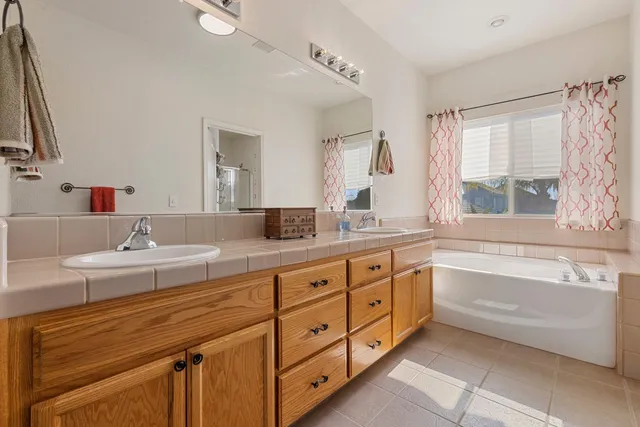 a bathroom with a sink a mirror and a shower