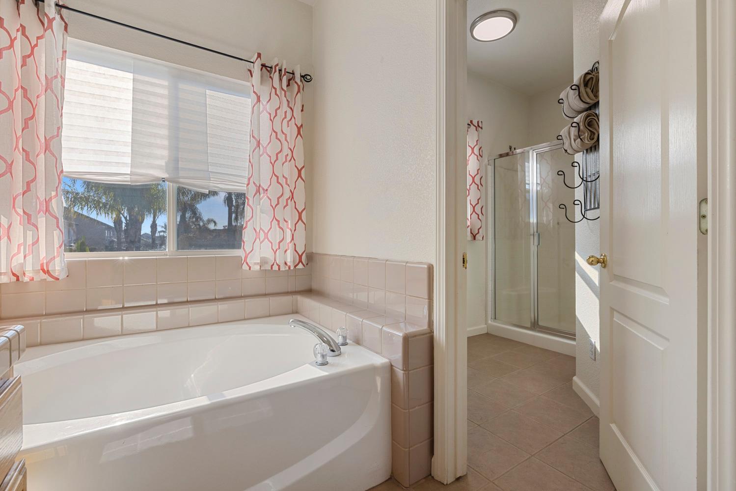 2730 Explorer Way Turlock, CA 95382 - Photo 40 of 64 a bathroom with a bathtub and a shower