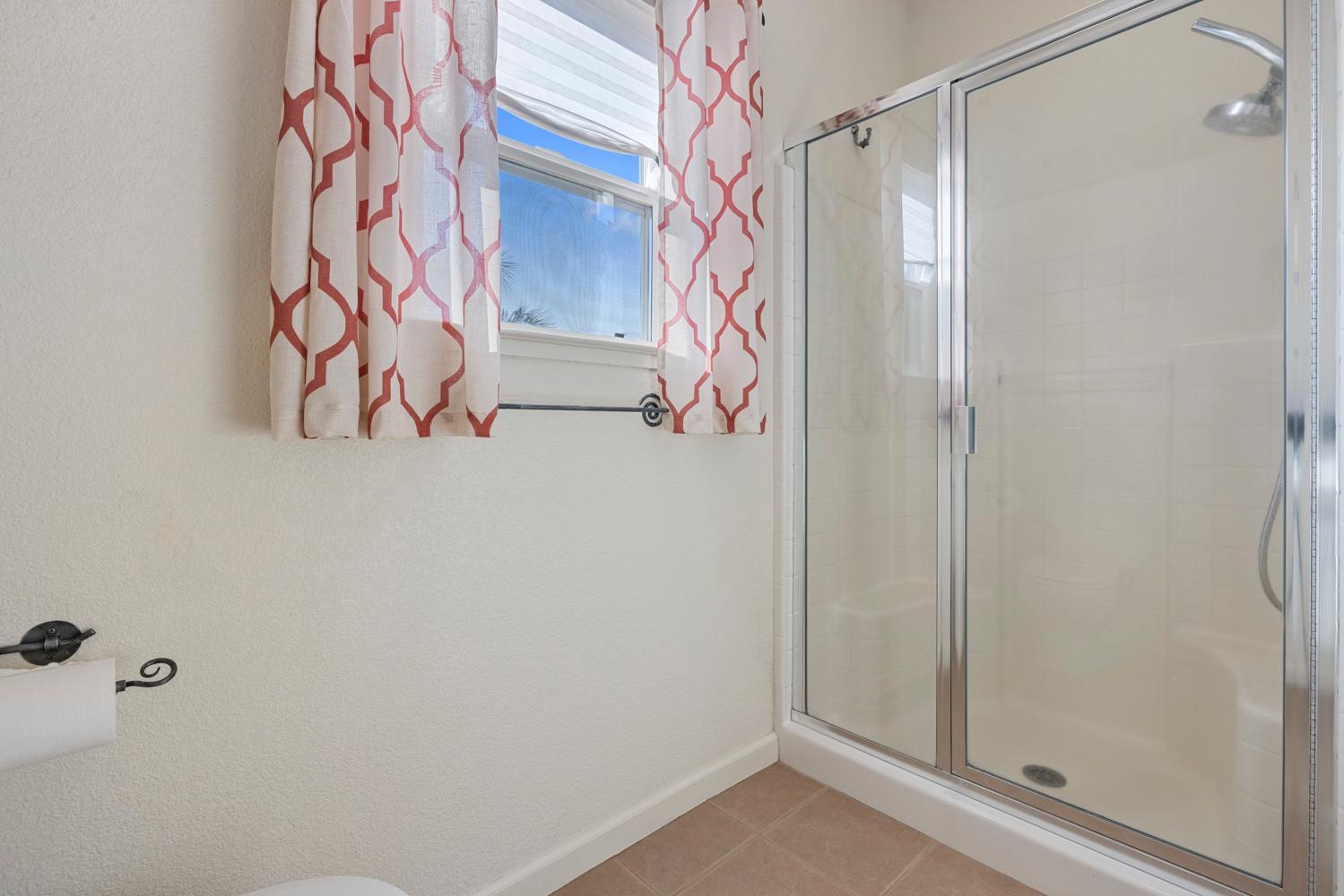 2730 Explorer Way Turlock, CA 95382 - Photo 41 of 64 a bathroom with a glass door shower and a sink