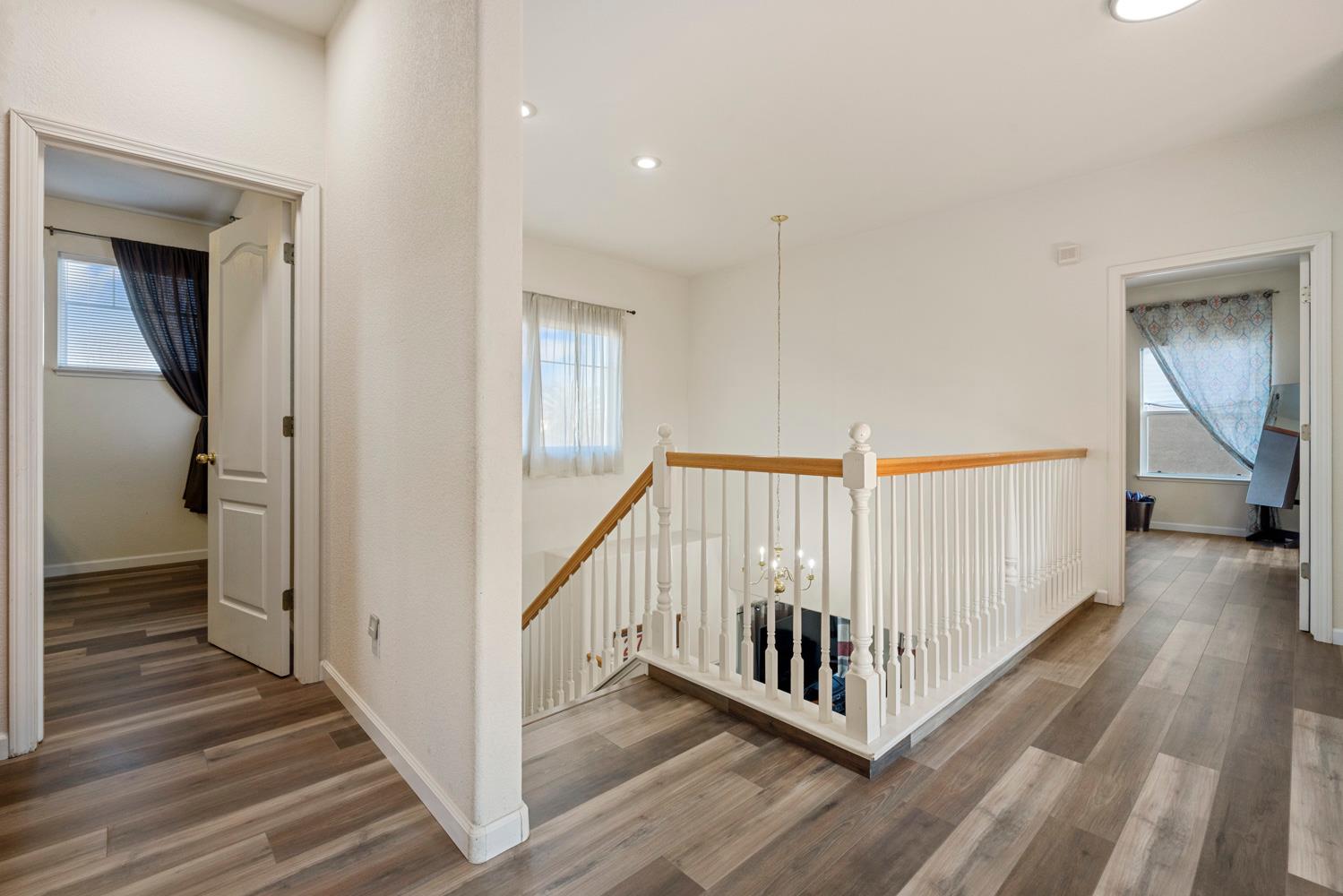 2730 Explorer Way Turlock, CA 95382 - Photo 46 of 64 a view of a hallway with wooden floor and stairs
