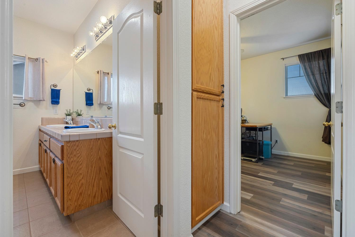 2730 Explorer Way Turlock, CA 95382 - Photo 49 of 64 a bathroom with a sink a mirror and a shower