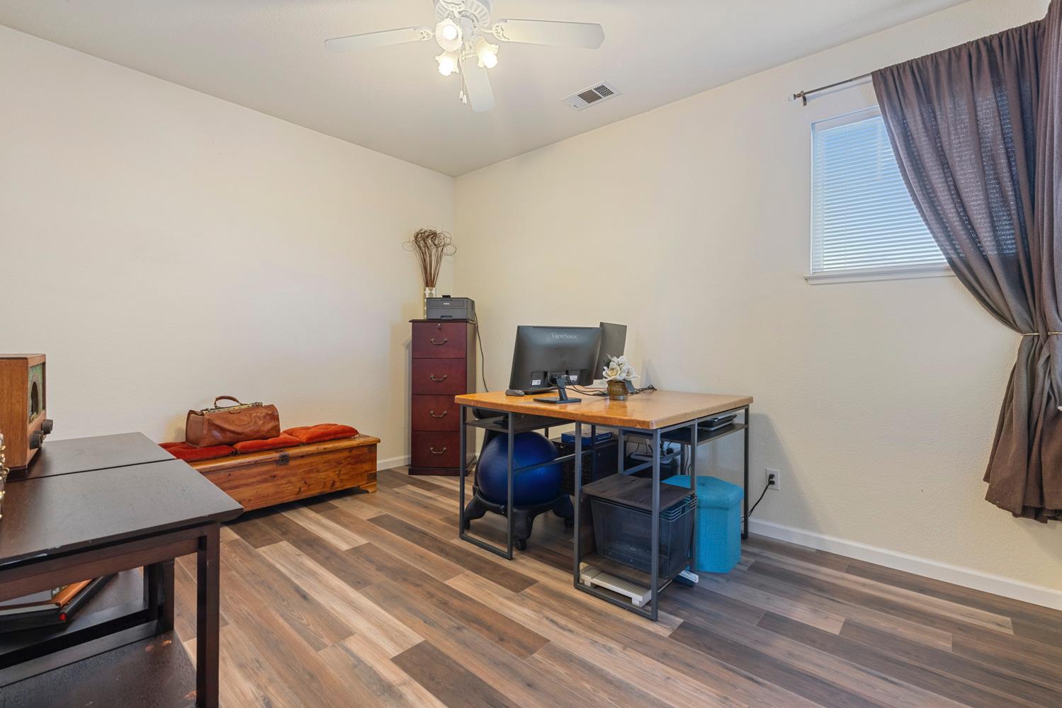 2730 Explorer Way Turlock, CA 95382 - Photo 50 of 64 a workspace with furniture and wooden floor