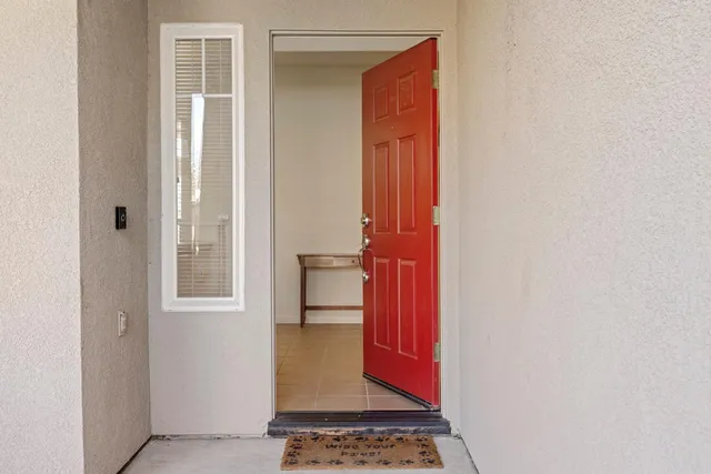 a view of a hallway with a door and a window