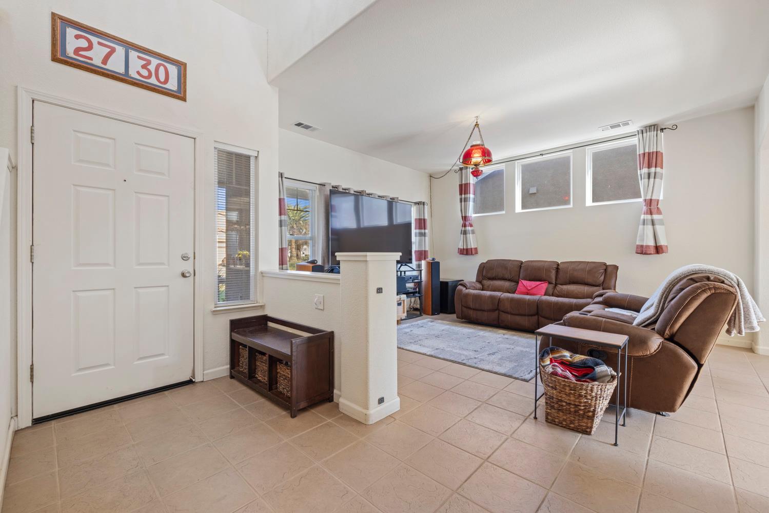 2730 Explorer Way Turlock, CA 95382 - Photo 7 of 64 a living room with furniture and a flat screen tv