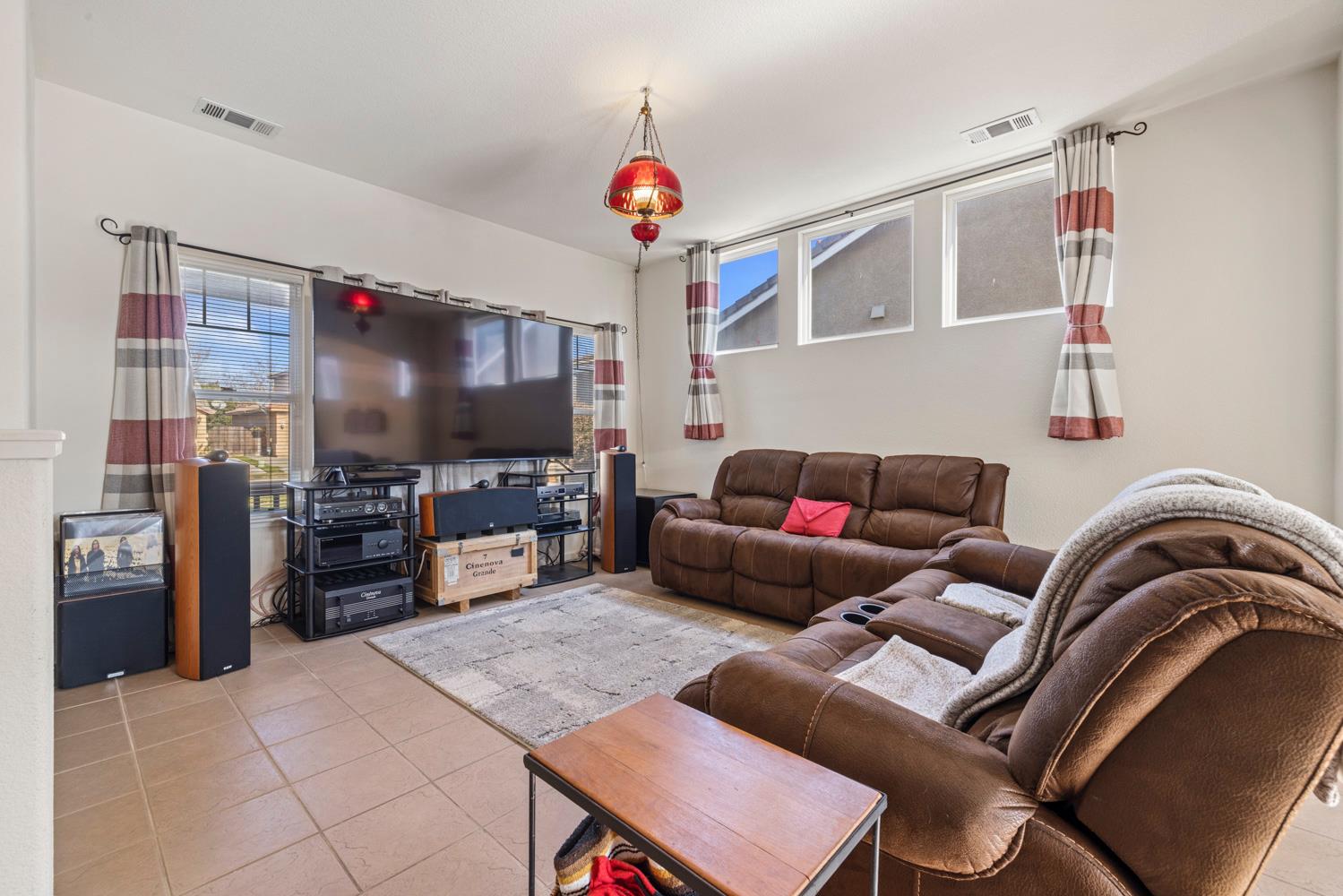 2730 Explorer Way Turlock, CA 95382 - Photo 8 of 64 a living room with furniture and a flat screen tv