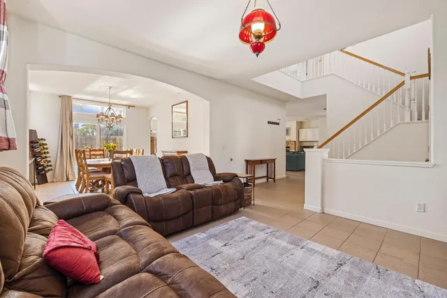 a dining room with furniture a chandelier and window