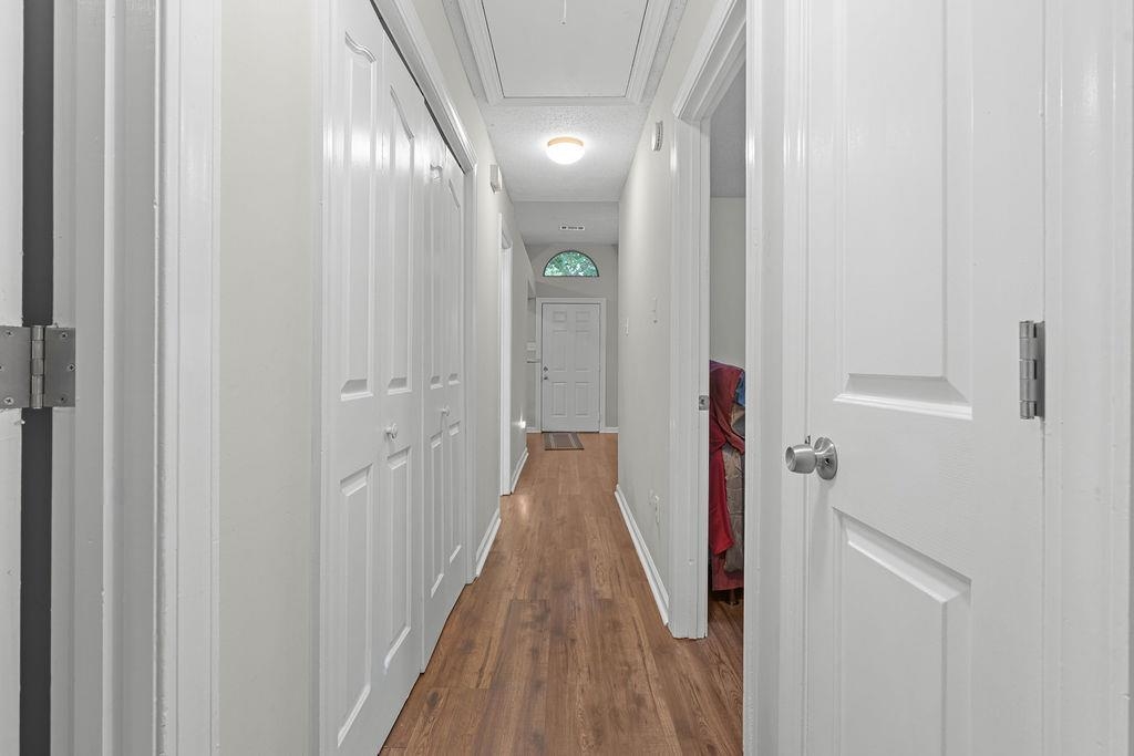 5340 Shady Ridge Cove Memphis, TN 38141 - Photo 11 of 22 Hallway featuring dark wood-style flooring and attic access