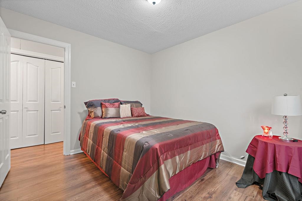 5340 Shady Ridge Cove Memphis, TN 38141 - Photo 14 of 22 Bedroom with wood finished floors and a textured ceiling