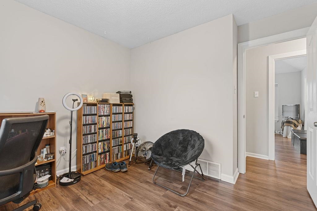 5340 Shady Ridge Cove Memphis, TN 38141 - Photo 16 of 22 Living area with wood finished floors, an office area, and a textured ceiling