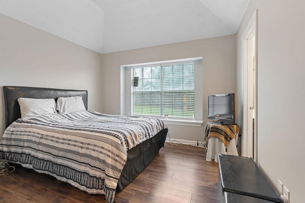 5340 Shady Ridge Cove Memphis, TN 38141 - Photo 17 of 22 Bedroom with dark wood-style floors and lofted ceiling