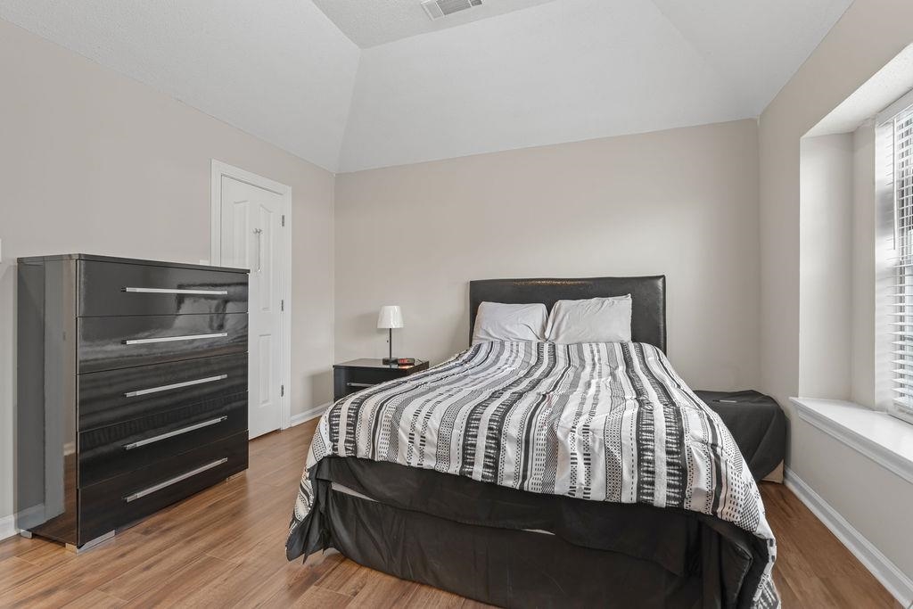 5340 Shady Ridge Cove Memphis, TN 38141 - Photo 18 of 22 Bedroom featuring wood finished floors and vaulted ceiling