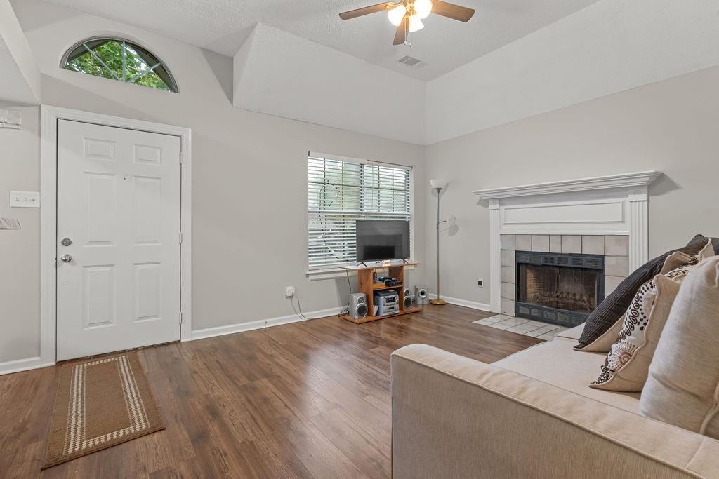 5340 Shady Ridge Cove Memphis, TN 38141 - Photo 4 of 22 Living area with plenty of natural light, a fireplace, wood finished floors, and a ceiling fan