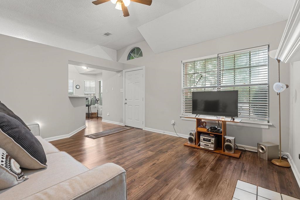 5340 Shady Ridge Cove Memphis, TN 38141 - Photo 5 of 22 Living area featuring lofted ceiling, ceiling fan, dark wood finished floors, and a textured ceiling