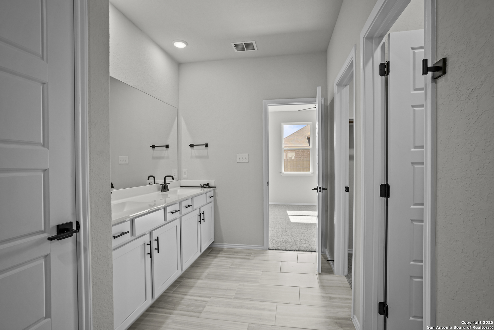 7420 Cremorne Converse, TX 78109 - Photo 19 of 40 a bathroom with a double vanity sink and a mirror