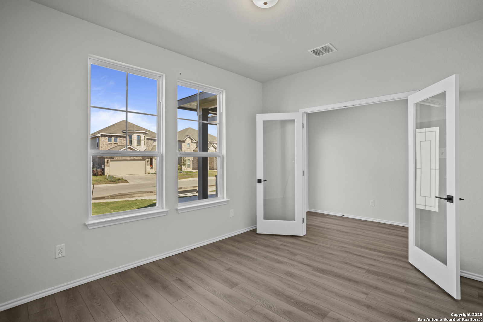 7420 Cremorne Converse, TX 78109 - Photo 6 of 40 a view of an empty room with a window and wooden floor