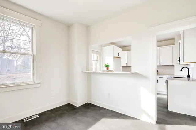 a view of kitchen with center island and windows