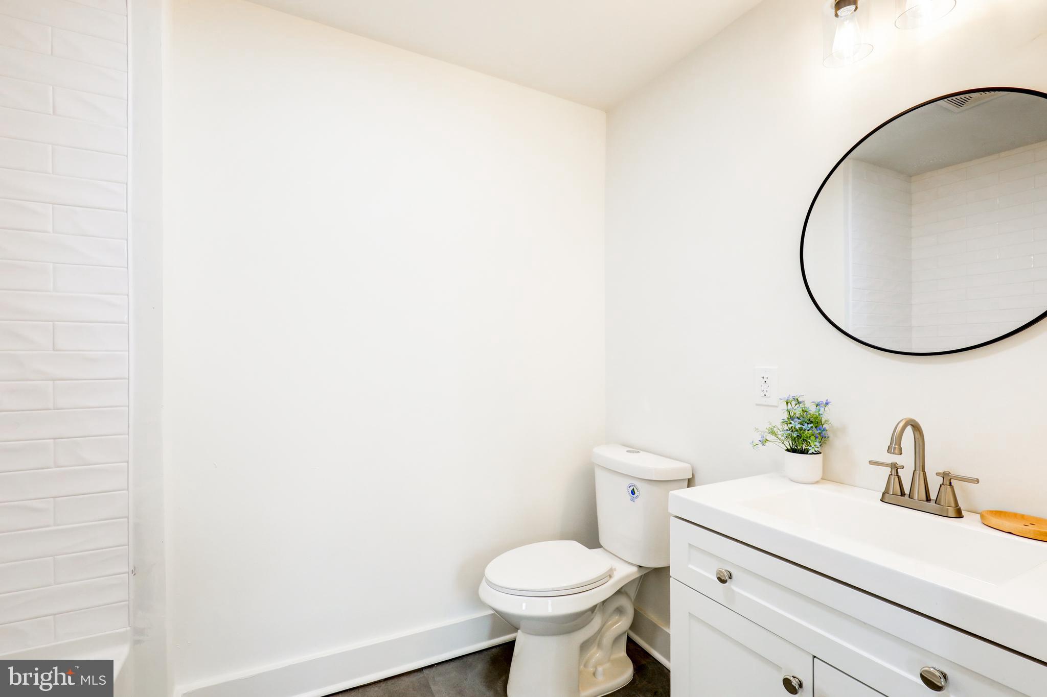 7301 North Radcliffe Street Bristol, PA 19007 - Photo 18 of 43 a bathroom with a sink a toilet and a mirror