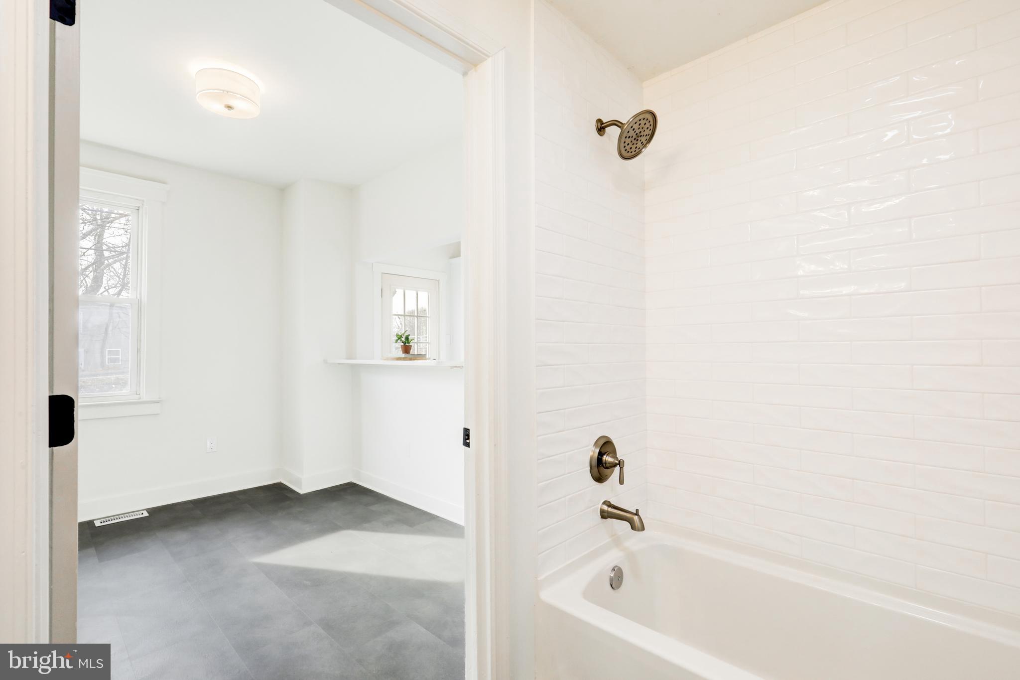 7301 North Radcliffe Street Bristol, PA 19007 - Photo 20 of 43 a bathroom with a bathtub and a shower