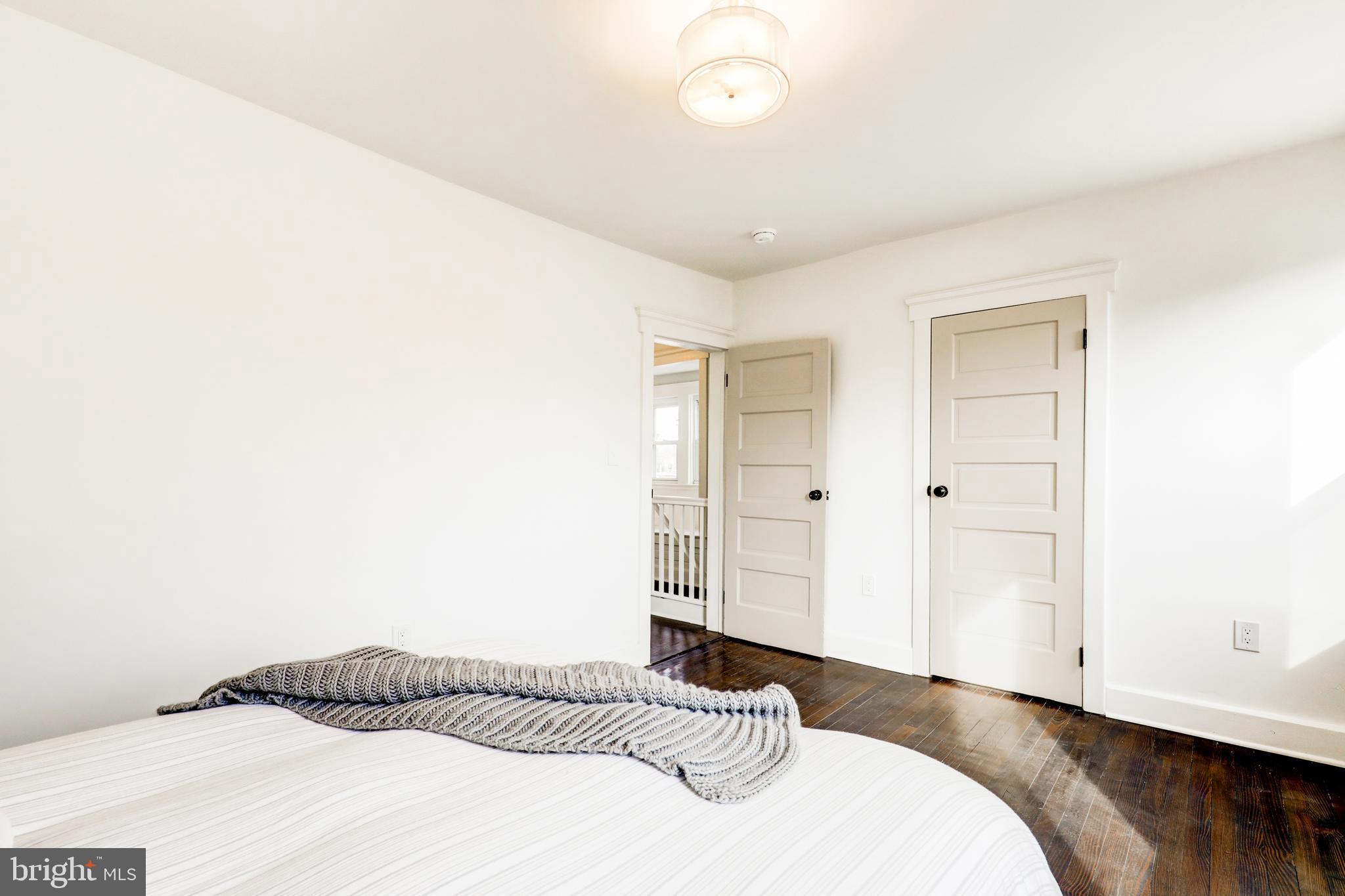 7301 North Radcliffe Street Bristol, PA 19007 - Photo 23 of 43 a bedroom with a bed and a night stand