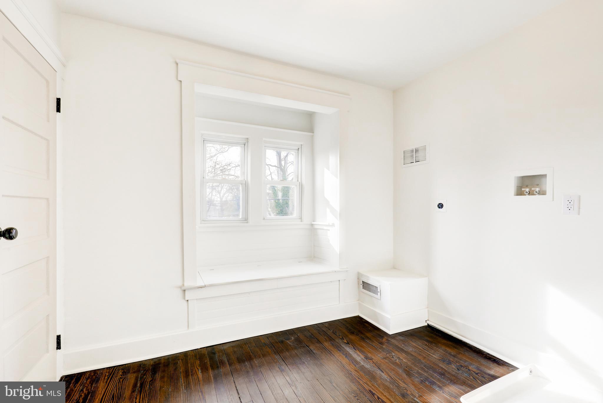 7301 North Radcliffe Street Bristol, PA 19007 - Photo 29 of 43 a view of an empty room with wooden floor and a window