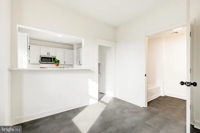 a view of a kitchen with microwave and cabinets