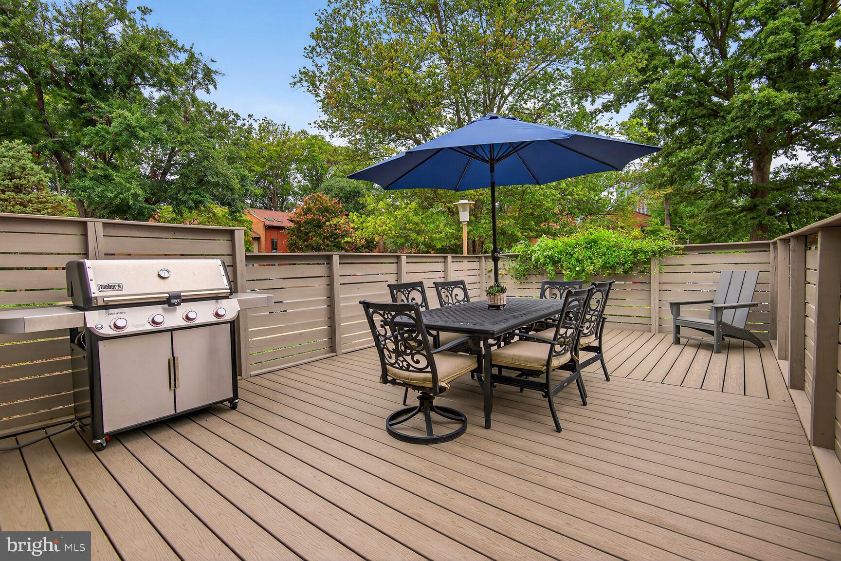 11775 Indian Ridge Road Reston, VA 20191 - Photo 2 of 29 a view of a roof deck with table and chairs under an umbrella with wooden floor