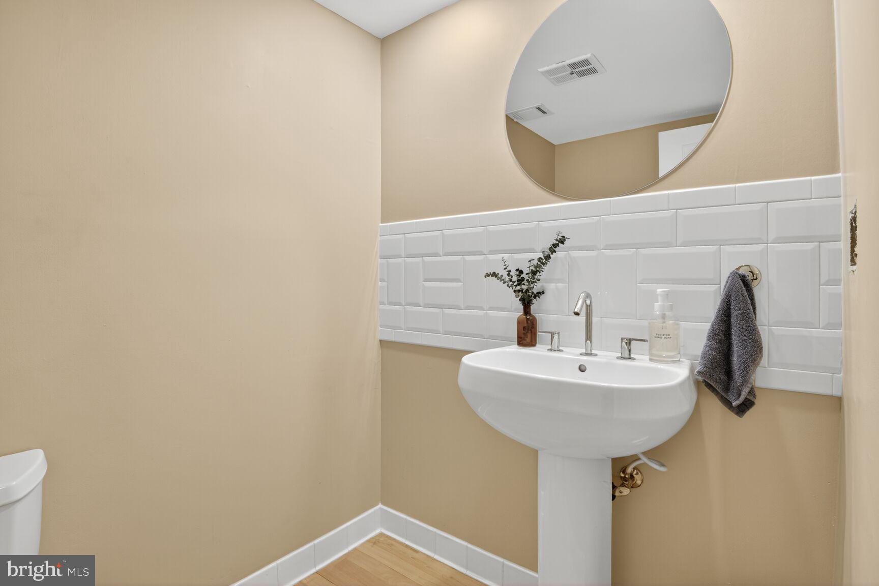 11775 Indian Ridge Road Reston, VA 20191 - Photo 24 of 29 a bathroom with a sink and a mirror