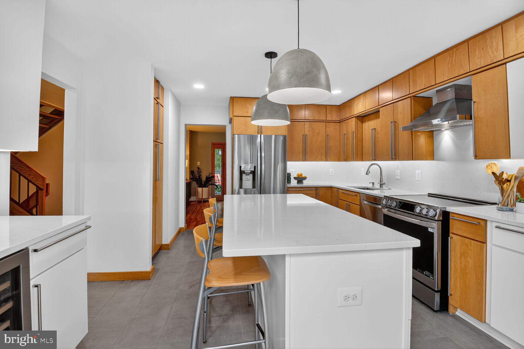 11775 Indian Ridge Road Reston, VA 20191 - Photo 5 of 29 a kitchen that has a sink a stove and a refrigerator