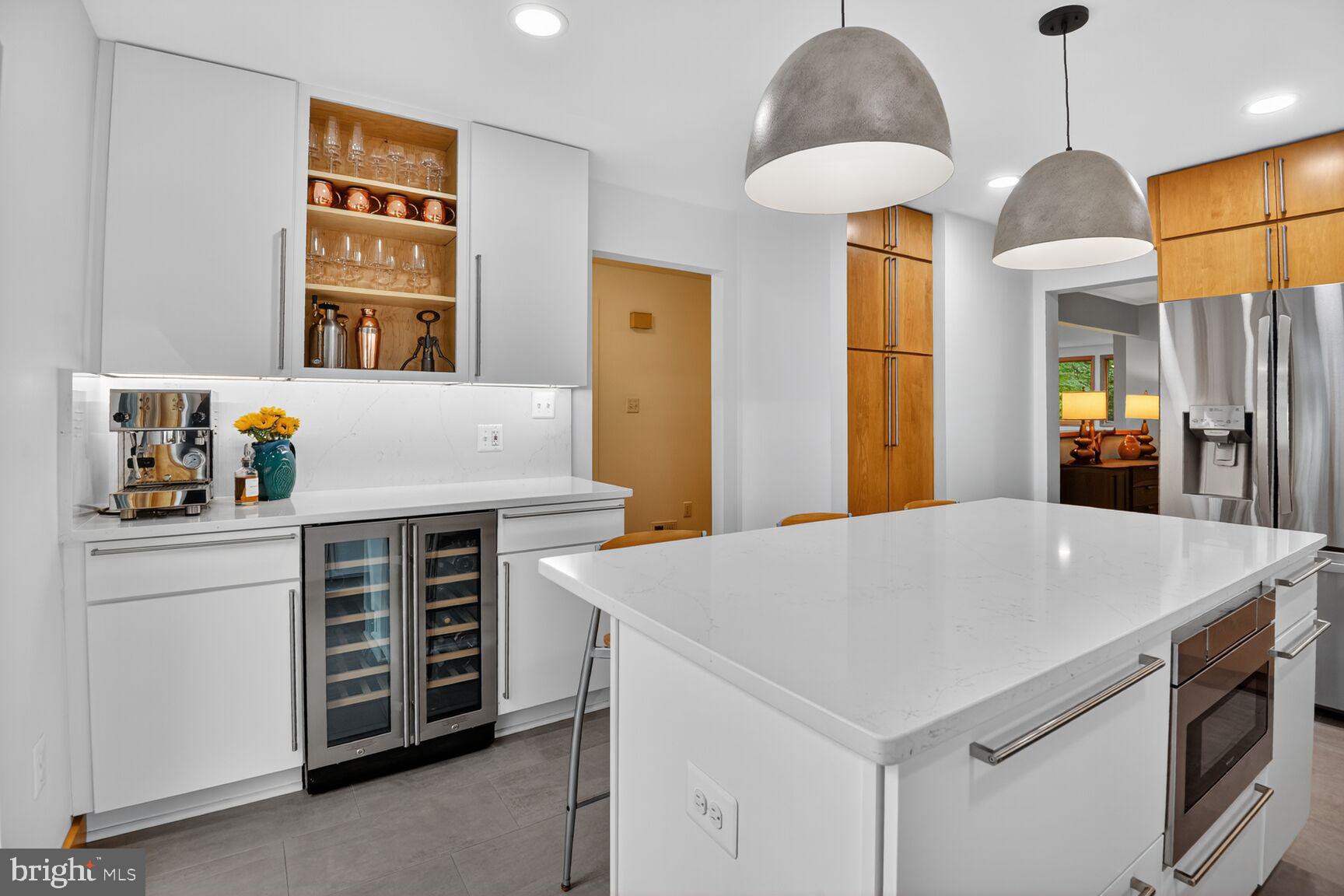 11775 Indian Ridge Road Reston, VA 20191 - Photo 6 of 29 a kitchen that has a stove a microwave a dining table and chairs