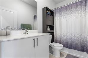 2781 Northwest 55th Way Lauderhill, FL 33313 - Photo 12 of 12 a bathroom with a sink a toilet and shower