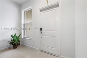 2781 Northwest 55th Way Lauderhill, FL 33313 - Photo 2 of 12 a view of a hallway with potted plants