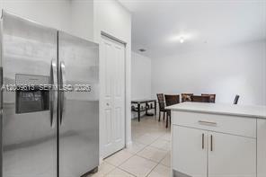 2781 Northwest 55th Way Lauderhill, FL 33313 - Photo 4 of 12 a kitchen with a refrigerator a sink and a stove top oven